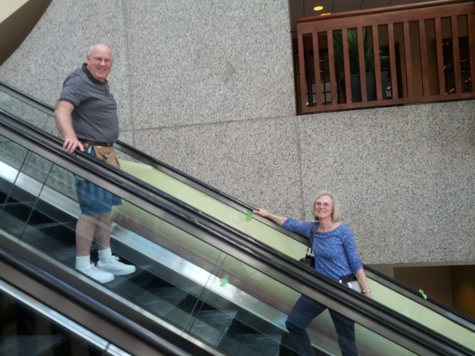 Two signage contractors posing with banner in progress