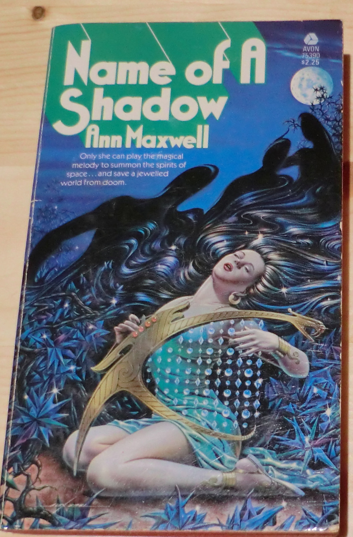 Name of a Shadow woman with her head thrown back in presumed bliss playing a harp with strings with crystals all over them. Ouch.