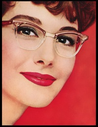 Red background lady in 50s glasses smiling with really nice lipstick on