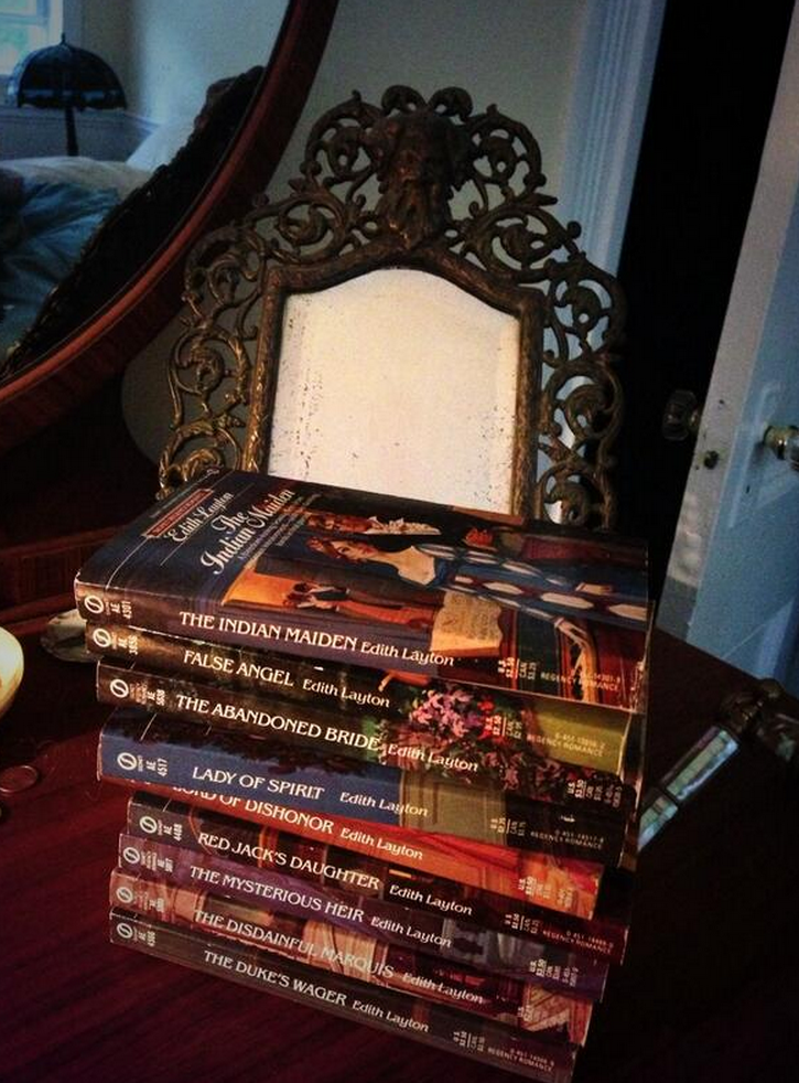 A stack of Layton novels on a table - including False Angel, The Abandoned Bride, Lady of Spirit, Red Jack's Daughter, The Disdainful Marquis and The Duke's Wager