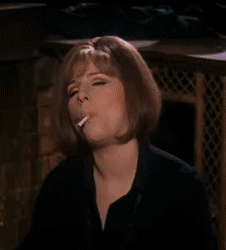 Barbra Streisand smoking a cigarette with a mighty puff 